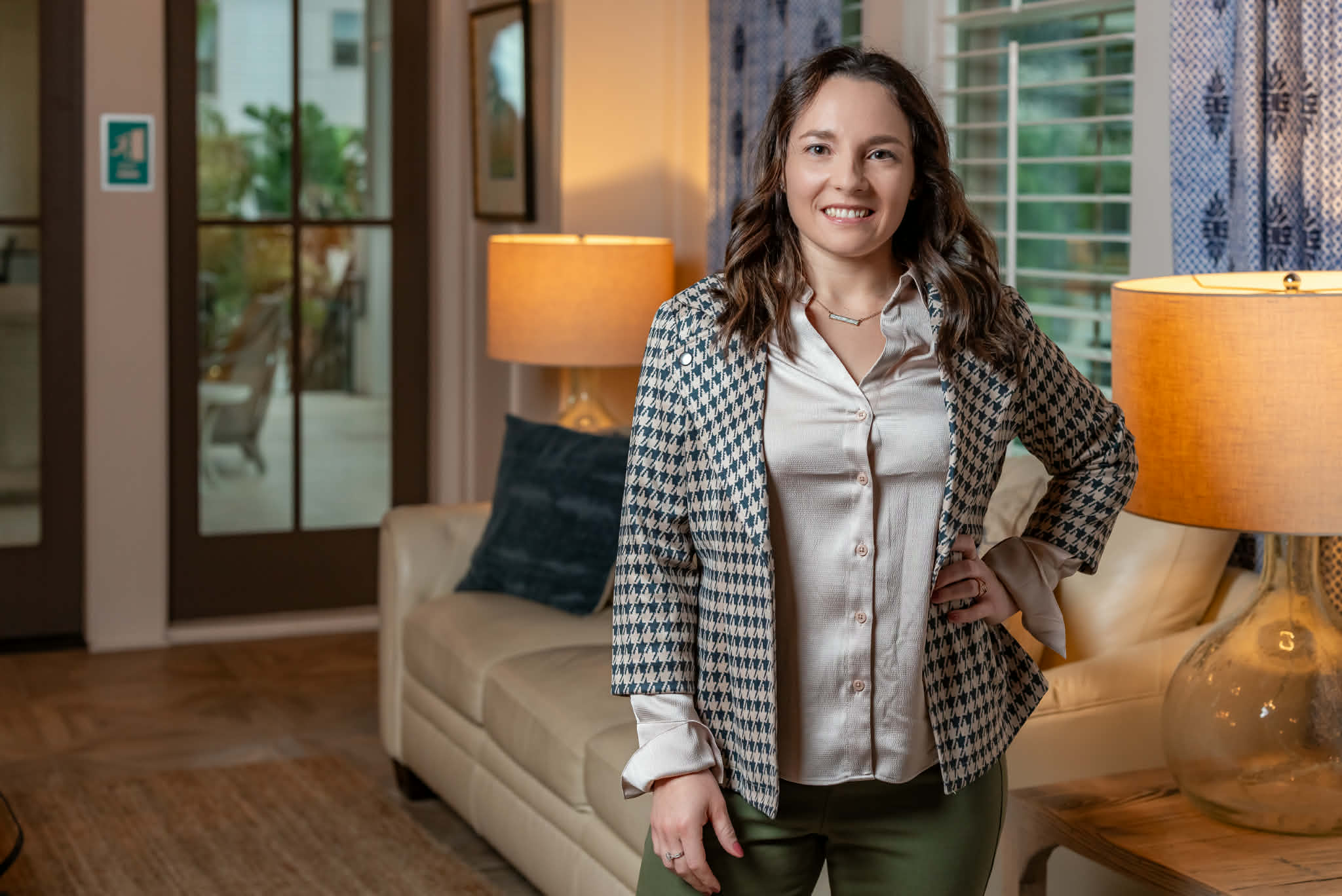 Elegantly staged living room with modern neutral sofa, wood coffee table, and coastal minimalist decor